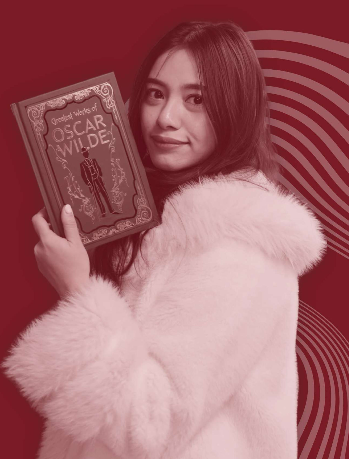 Jel Pamela in a pink faux-fur coat holding a copy of Greatest Works of Oscar Wilde